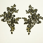 Black and gold mirrored pair applique embroidered onto a fine black net backing. The gold cord outlines all the leaves stems and flowers.