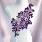 Single purple floral applique with bronze 3D flowers.  The flowers have a crystal centre and the leaves are outlined in bronze and embellished with small metallic purple sequins.  The applique is displayed on a mannequin.