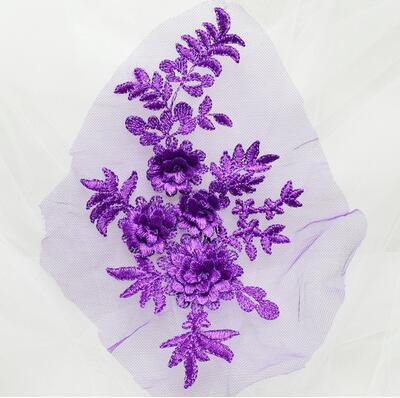 Purple embroidered floral applique with 3D flowers.  The applique is displayed on a white background..