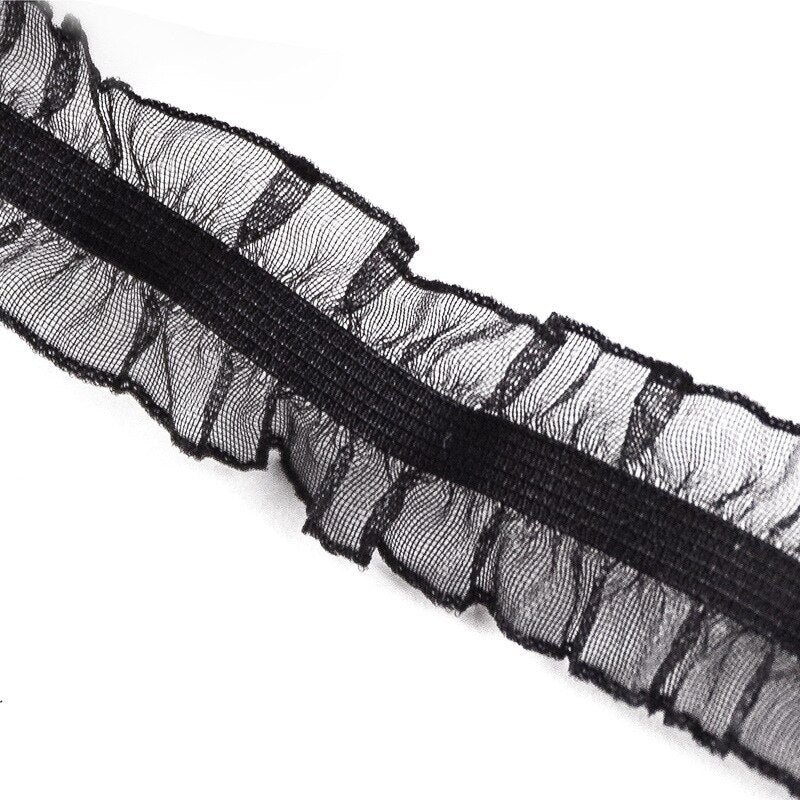 Black elastic stretched and sewn into the centre of a 2.5cm  black organza to create  an elasticated ruffled trim .