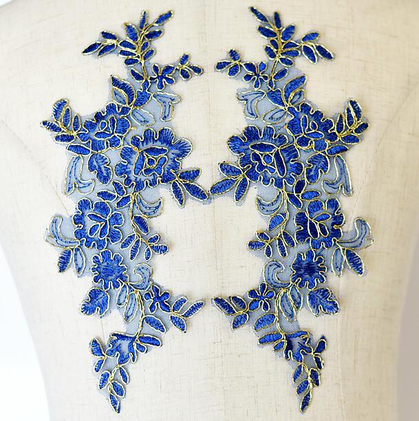 Royal blue floral applique pair edged with metallic gold cord.
