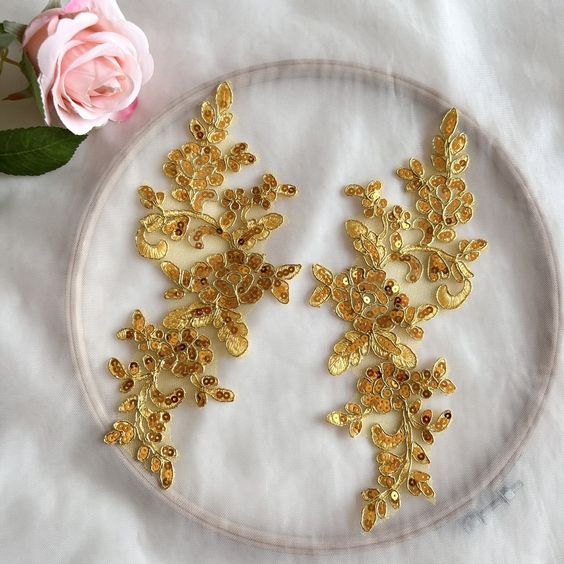 Gold applique with gold cording a bright gold sequins in a floral design .