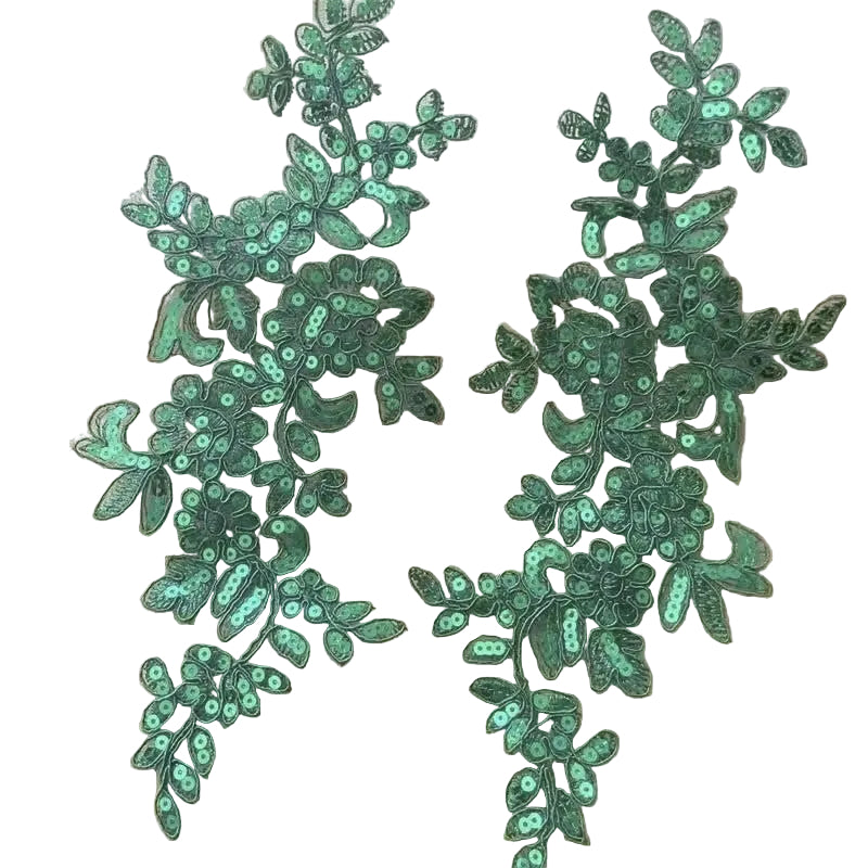 A pair of green sequined leaf applique patches displayed on a  white background
