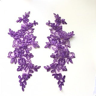 Mirrored pair of purple corded appliques.