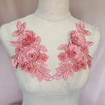 Pink embriodered applique with 3D flowers which have pink pearl and crystal centres.