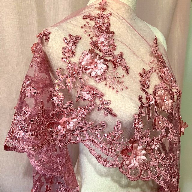 Dusty pink floral border lace with 3D flowers with pearl centres and tiny pink sequins on the stems and leaves, draped across a mannequin 