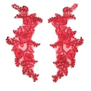 A pair of red floral corded appliques on a white background