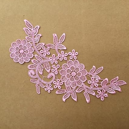 Pink venise lace applique featuring two large flower shapes on swirled stems .