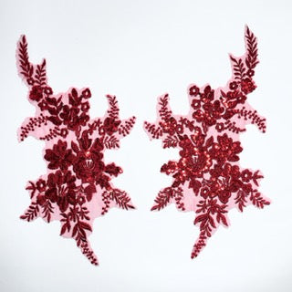 Heavily embroidered pair of burgundy appliques embroidered onto a fine burgundy net. The flower and leaf shapes are highlighted with red sequins giving a lovely sparkle under lights. 