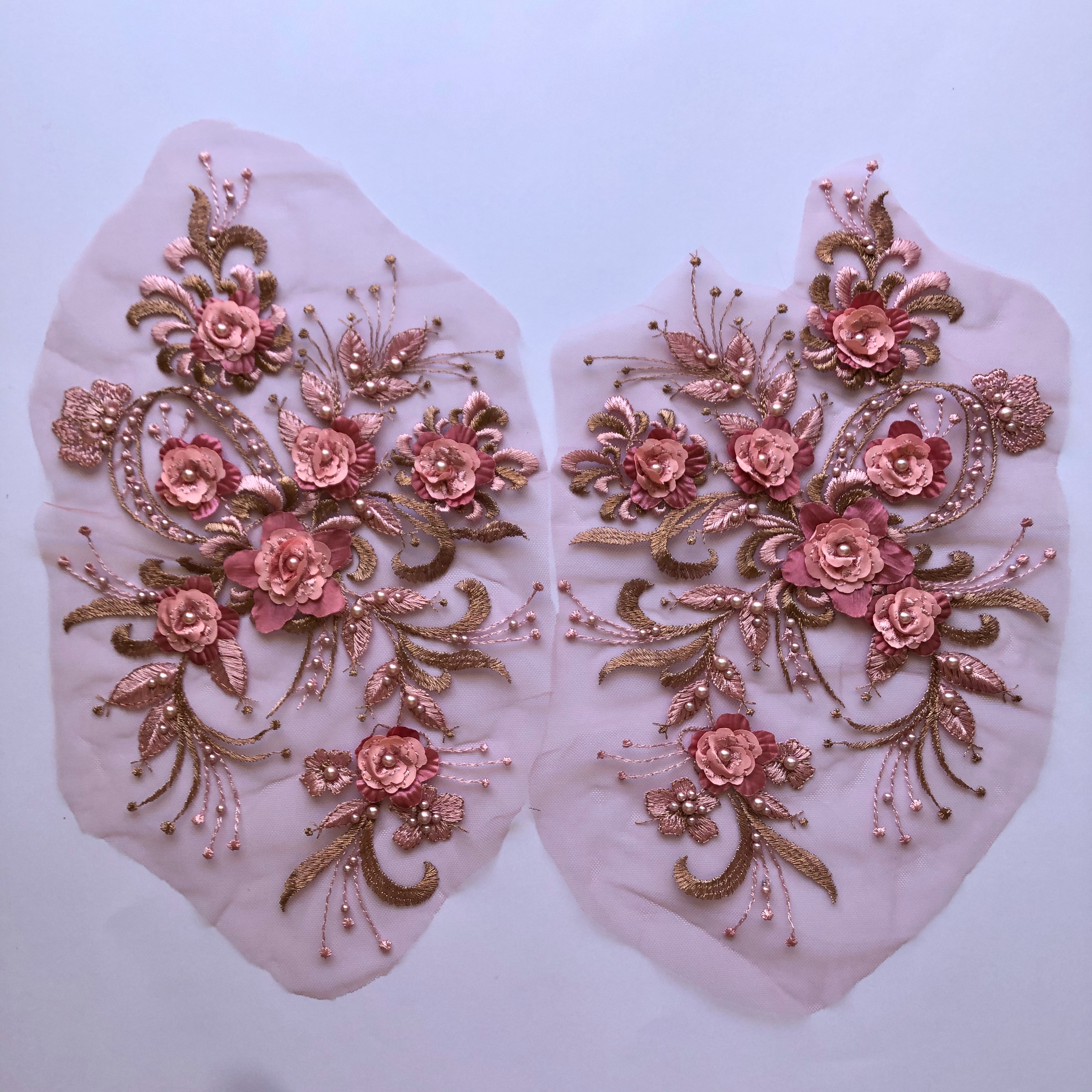 Mirrored pair applique with 7 pink layered flowers and a background of pink and pale bronze metallic leaves.. Embroidered onto a thin net.