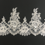 Heavily embroidered corded floral lace design featuring a scalloped border with an alternating rose and hearts pattern.  The lace is sprinkled with clear sequins which would look beautiful on a wedding veil or wedding dress.