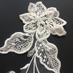 Ivory floral lace applique pair embroidered onto a fine net backing.  Large feature flower has a daisy flower embroidered into the centre.