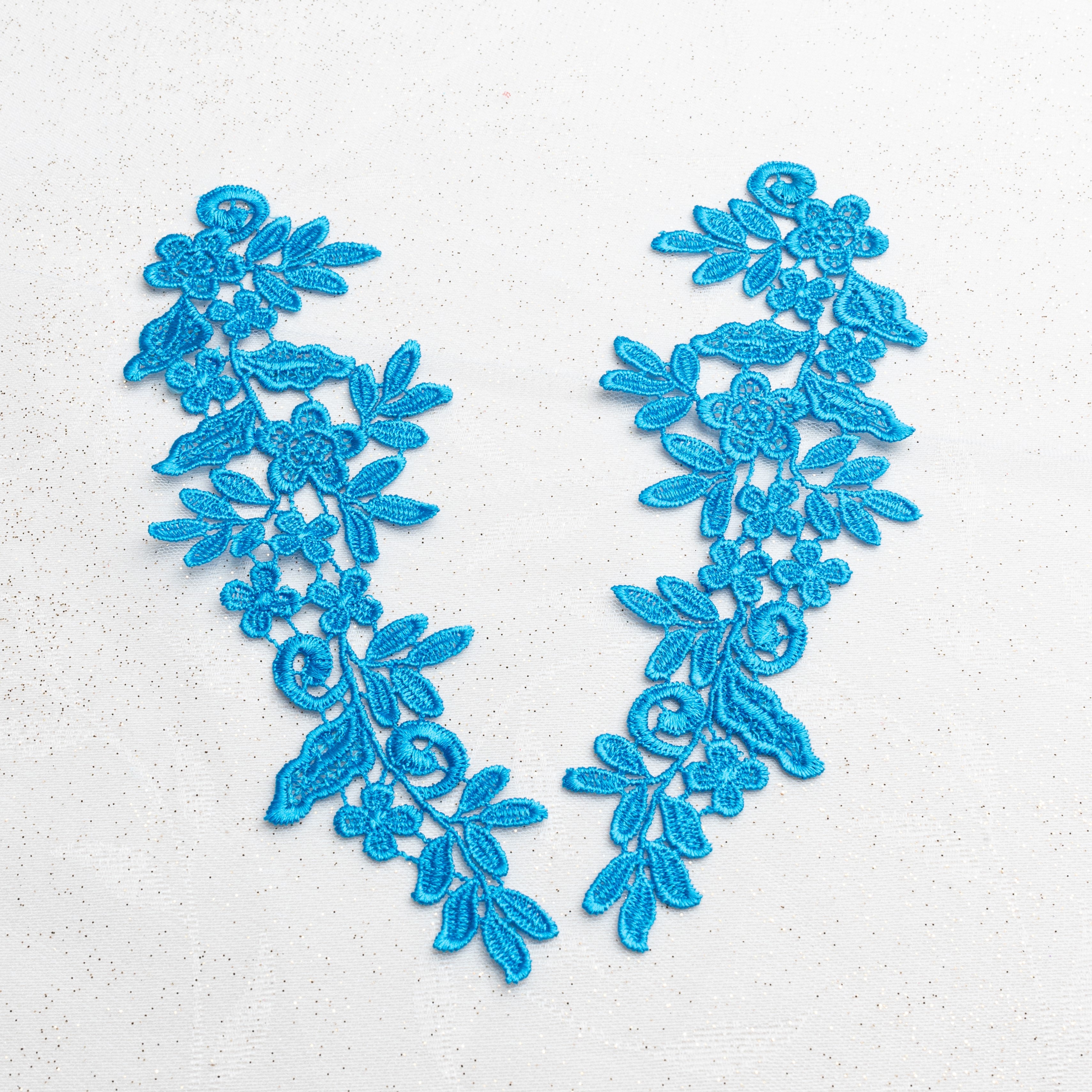 Heavily embroidered blue lace applique pair with a floral design.  This versatile applique pair can be embellished and decorated with crystals, pearls, beads and sequins for beautiful dance and stage costumes