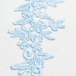 Heavily embroidered pale baby blue mirrored lace applique pair. The floral design is a perfect background for decorating with crystals, pearls, sequins and beads and can be cut up and rearranged into smaller motifs to decorate dance costumes.