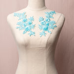 Ice blue embroidered floral applique pair with 3D flowers.  The applique pair is displayed on a mannequin.