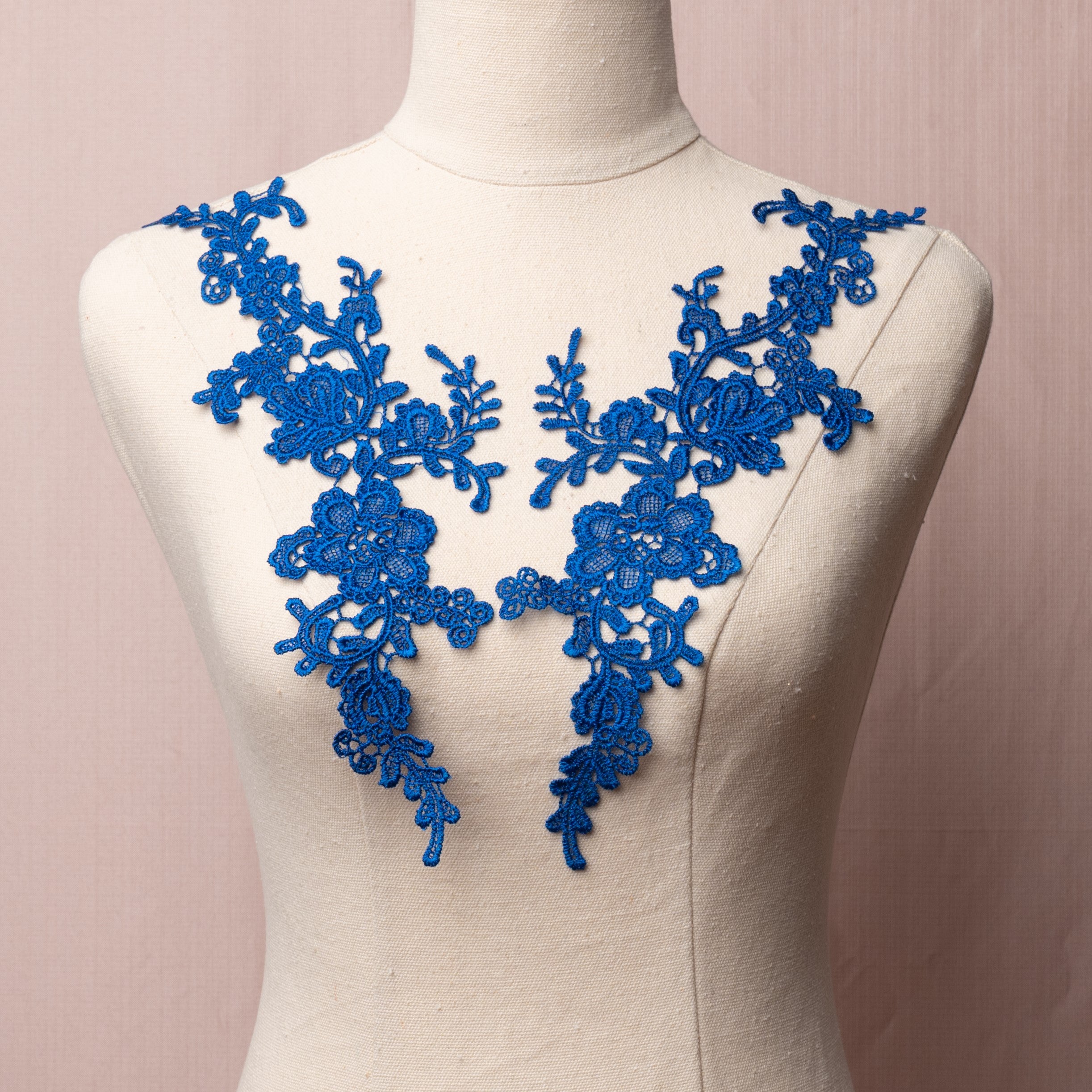 Heavily embroidered royal blue lacy floral applique pair.