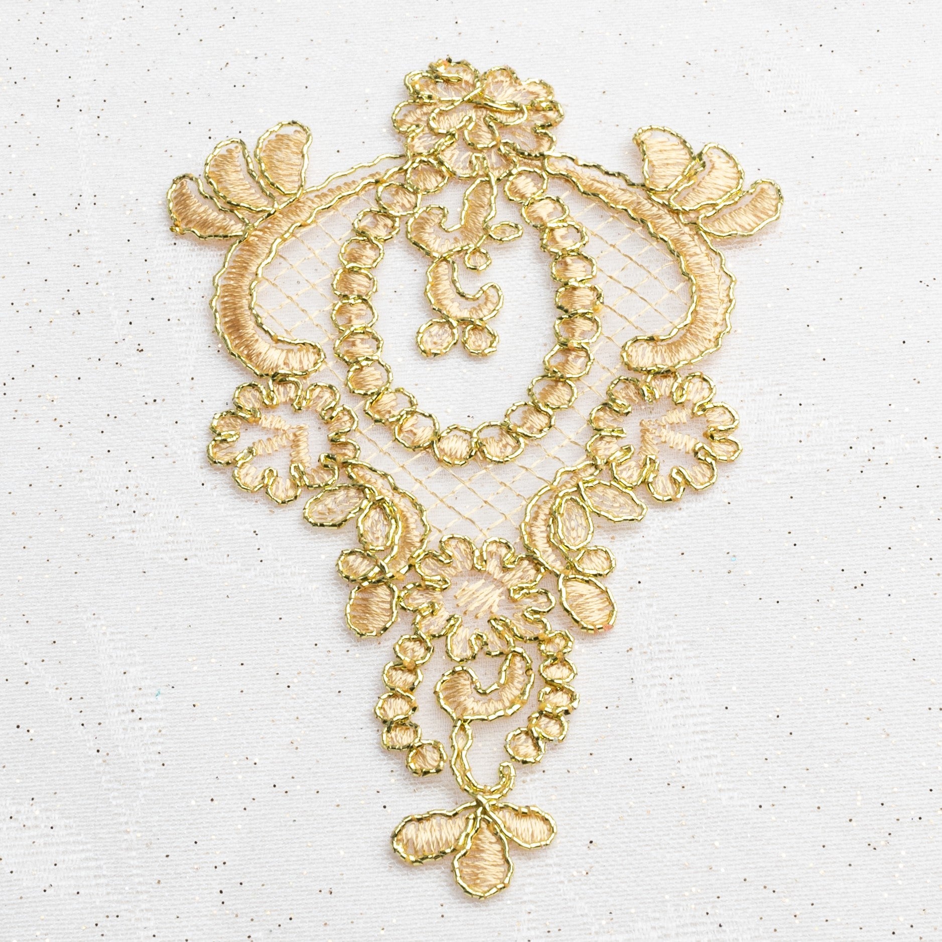 Single gold applique embroidered onto an organza backing and edged with bright gold cord.  A lovely applique for a ballet tutu bodice or skirt or for a boys military or royal costume.