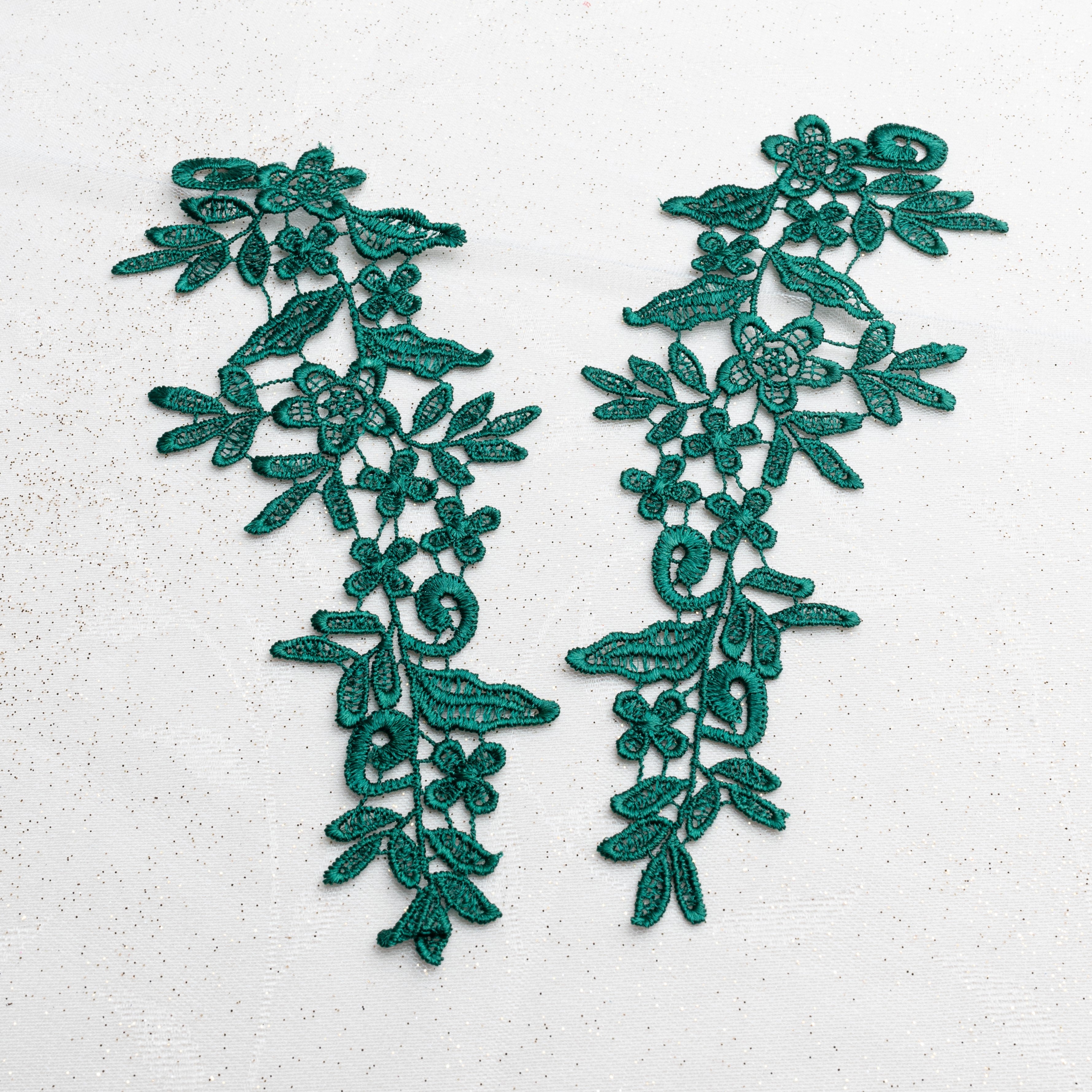 Heavily embroidered dark green lace applique pair with a floral design. This versatile applique pair can be embellished and decorated with crystals, pearls, beads and sequins for beautiful dance and stage costumes.