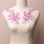 Soft purple embroiderd applique pair with floral design and 3D flowers displayed on a mannequin.