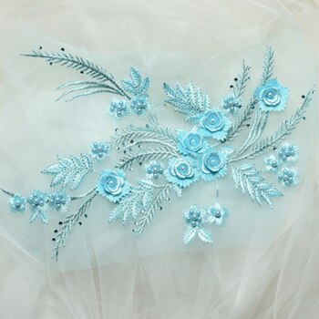 An embroidered  floral spray of satin and metallic threads. The blue costume applique features multi layered embroidered flowers with blue pearl centres and metallic embroidered fern fronds.  The blue floral appliques come as a mirrored pair making them suitable for costume and tutu bodices and tutu plates. 