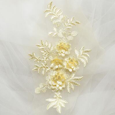 Single cream embroidered floral applique with 3D flowers on a net background.