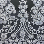White floral lace embroidered onto a net backing is a beautiful decoration for a wedding dress and veil, bridal wear and a tutu plate trim.