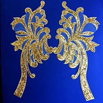 A large gold sequinned mirrored pair with swirls in a palm tree like design.  Embroidered onto a fine net backing the applique is edged with a satin stitched gold thread while the interior is completely filled with rows of tiny gold sequins . Each motif can be easily cut uses separately. Beautiful as wing flourishes on a white or black swan costume. 
