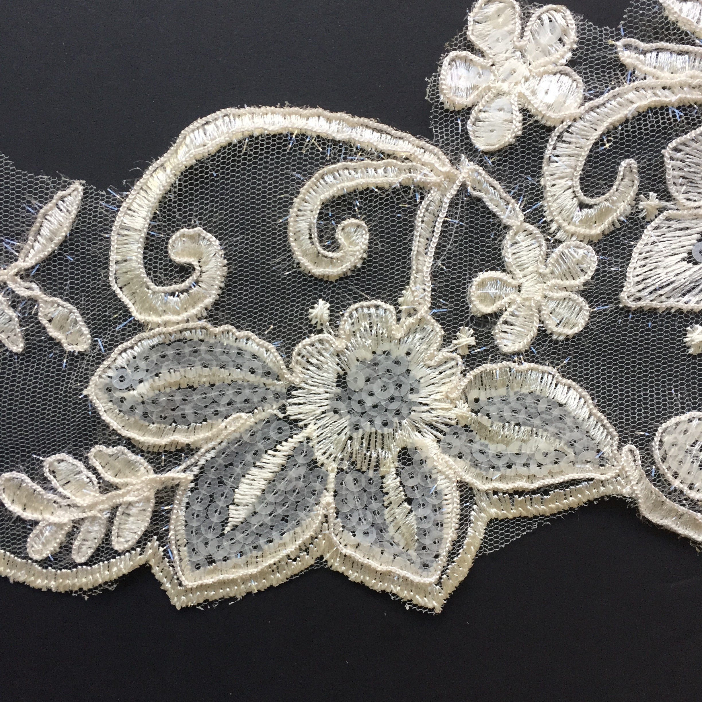 The embroidered lower edge follows the outline of the motifs making an interesting feature for the bottom of a tutu plate, costume or bridal veil.