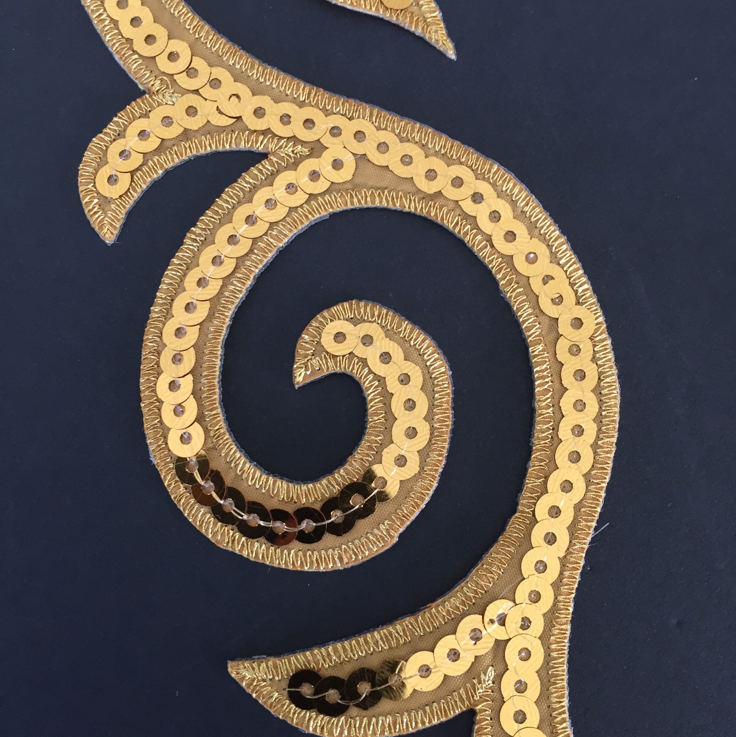Iron on Cosplay Gold Scrolls have an embroidered edge and are filled with a sequin strand . Perfect for boys dance and stage costumes and military style costumes .