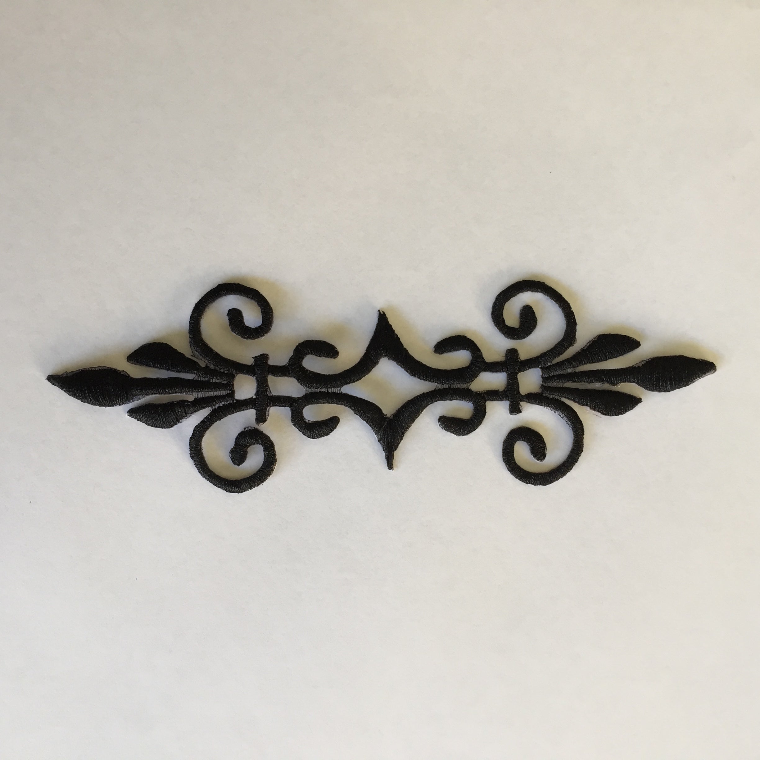 Embroidered black scroll applique for decorating cosplay costumes and ballet and dance costumes.