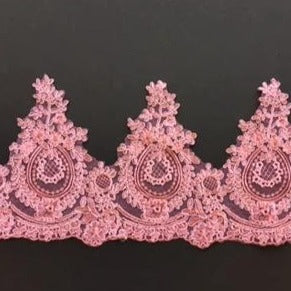 Very pretty pink floral scalloped lace with arepeated medallion pattern which sits on a scalloped lower edge . Densley embroidered onto a pink net backing the lace has a vintage style and would be perfect for decorating and embellishing a traditional tutu.