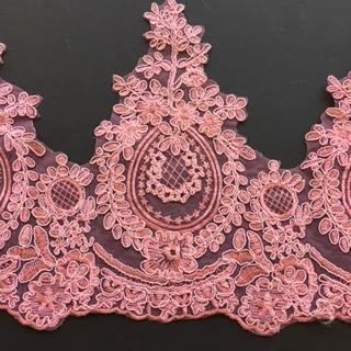 A Victorian styled lace with medallion motifs surrounded by a garland of leaves and topped by a triangular spray of daisy stems. A stunning medium to deep pink in colour .