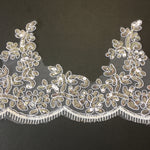A very sparkly white cord and silvery sequin trim with white eyelash border scallop.  Suitable for fairy tutus and dress-up and play costumes. 
