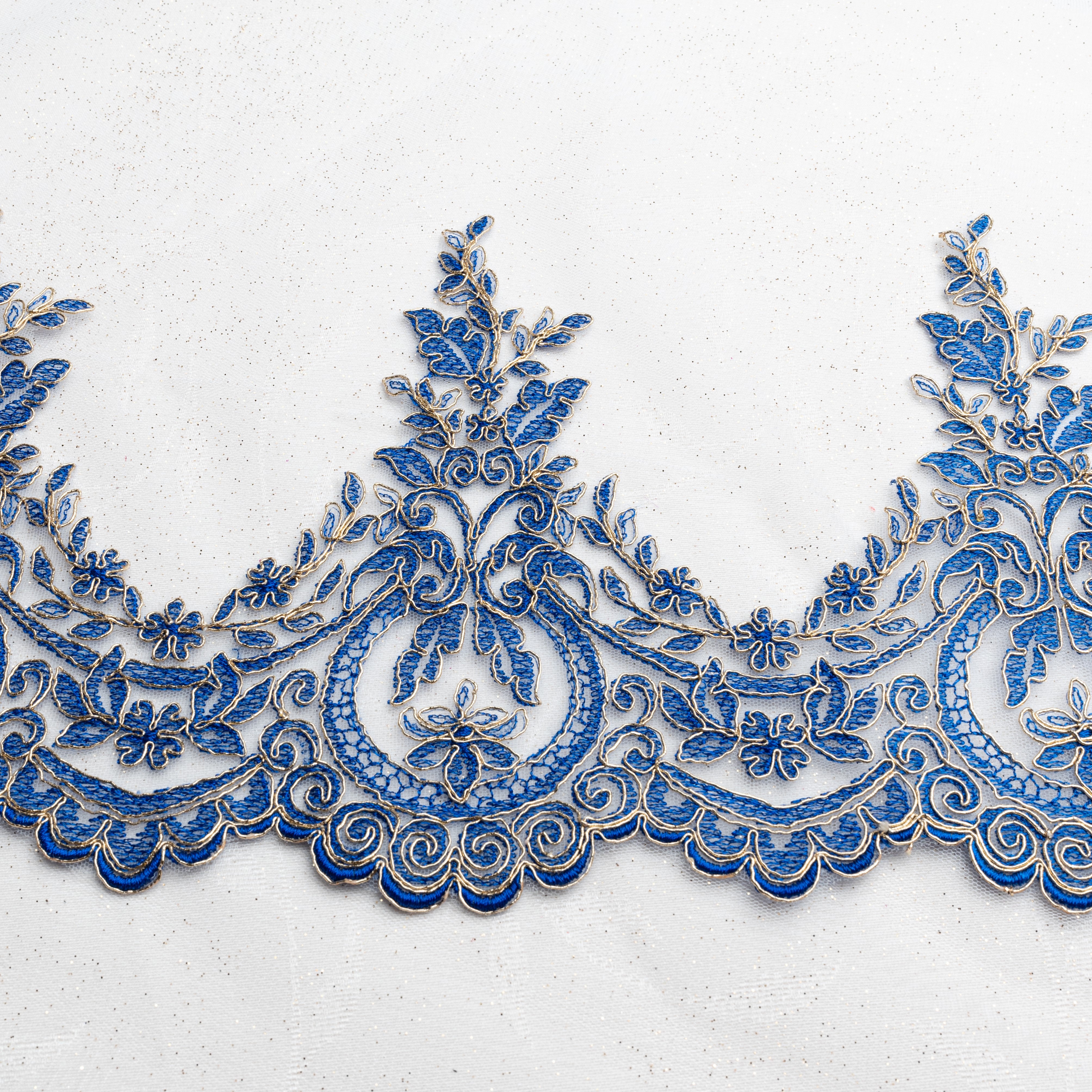 Royal blue and gold border lace embroidered with royal blue thread on a fine net backing with gold cord outlining the floral design. A very regal lace. The size is 23 cm high with a 17 cm pattern repeat.