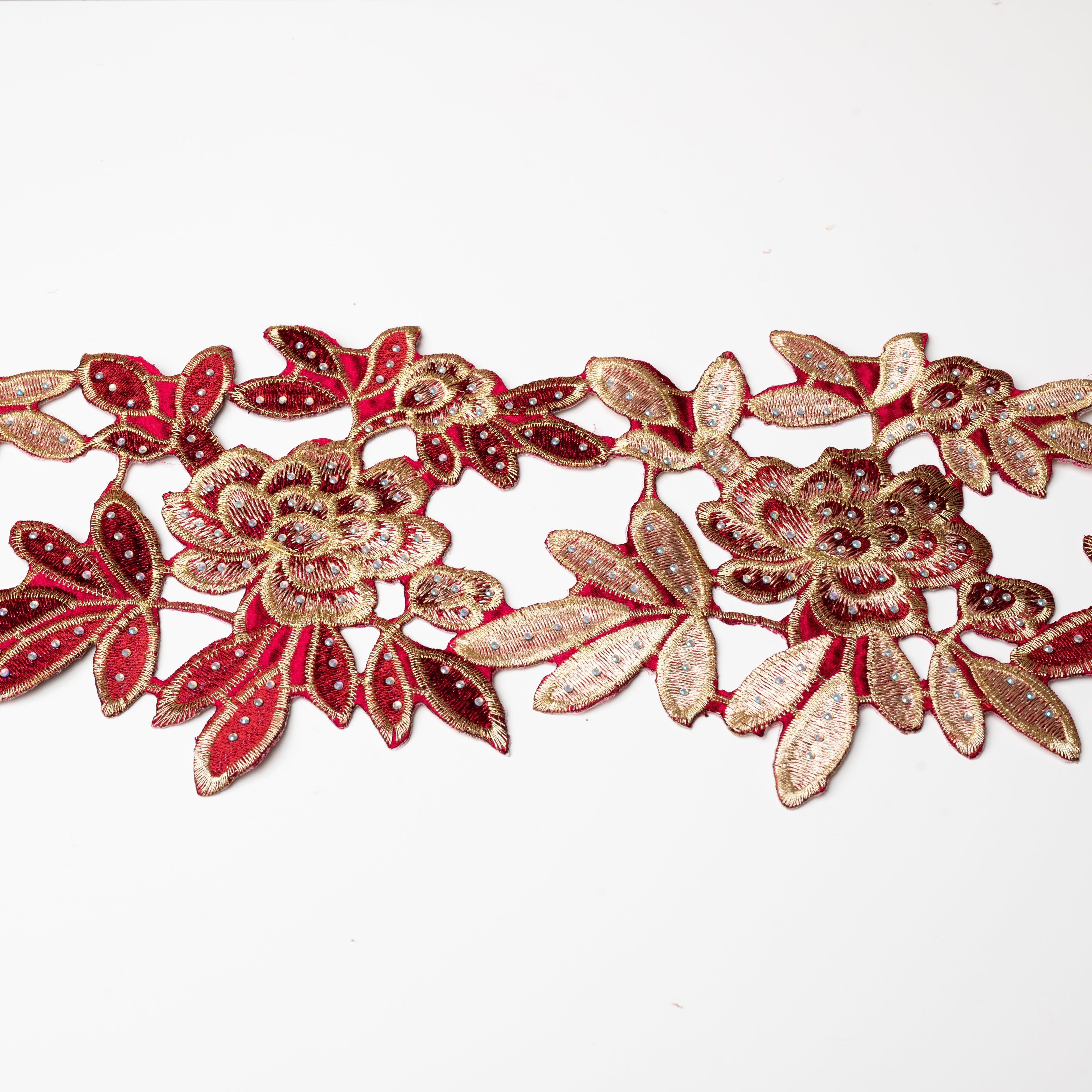 Heavily embroidered burgundy and gold floral iron on applique scattered with hot fix AB crystals.  The petals and leaves are outlined with gold thread.
