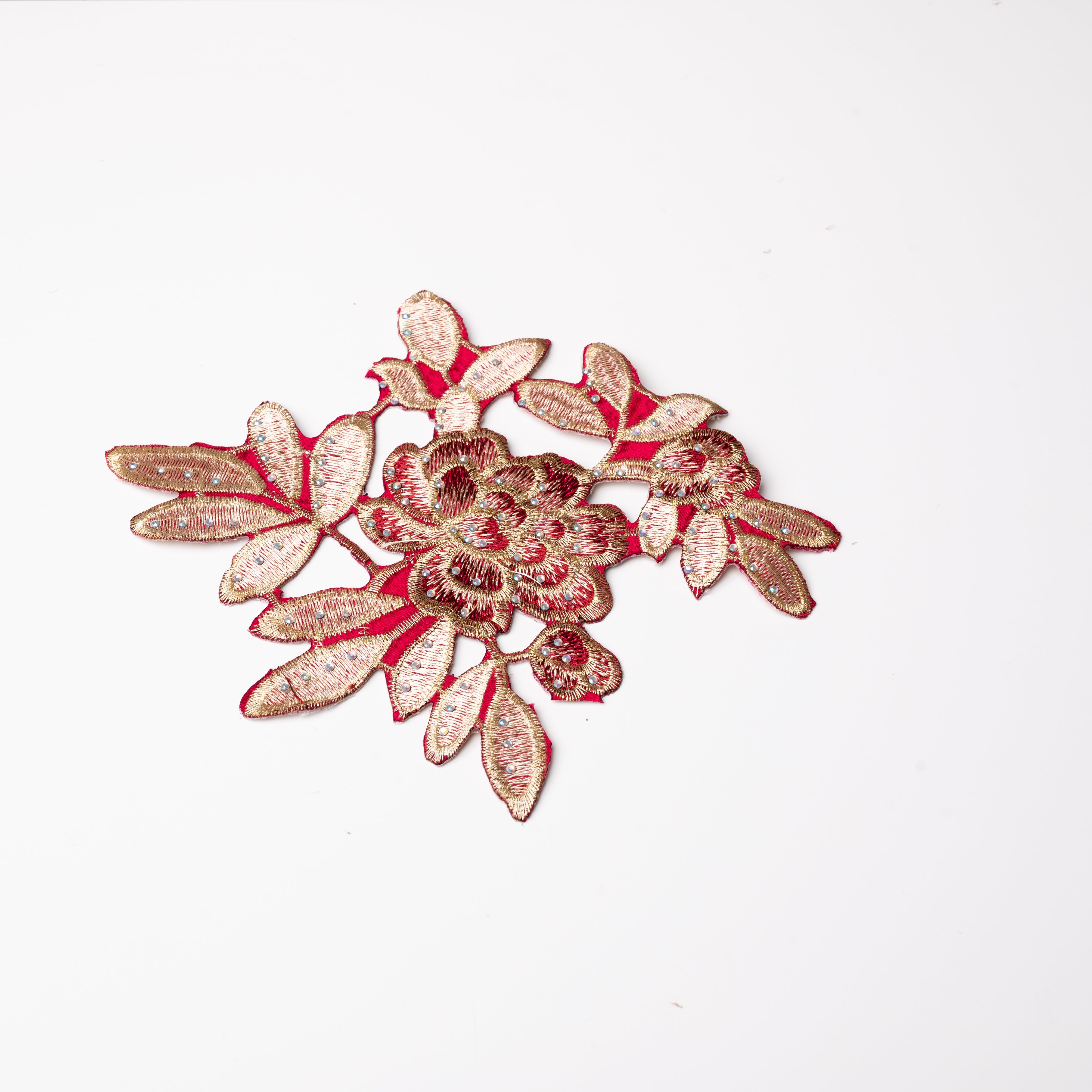 Heavily embroidered burgundy and gold floral iron on applique scattered with hot fix AB crystals.  The petals and leaves are predominantly gold and are outlined with gold thread.