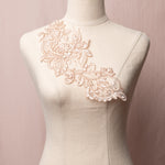 Single rose gold floral appliques embellished with clear sequins displayed on a mannequin.