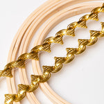 Metallic gold crocheted braid displayed across a set of embroidery rings.  The bright gold cord forms a three cord scalloped design on the lower edge and peaks on the upper edge.  A soft gold gold ribbon strip runs through the centre of each  motif.