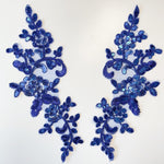 Royal blue sequinned and corded floral applique pair .
