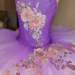 Purple ballet tutu decorated with 3D pink and lavender floral appliques on the bodice and tutu plate 