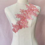 Large pink applique with a floral design and outlined with cold.  The applique is perfect for dance and stage costumes and can be embellished with crystals,  sequins and beads.  