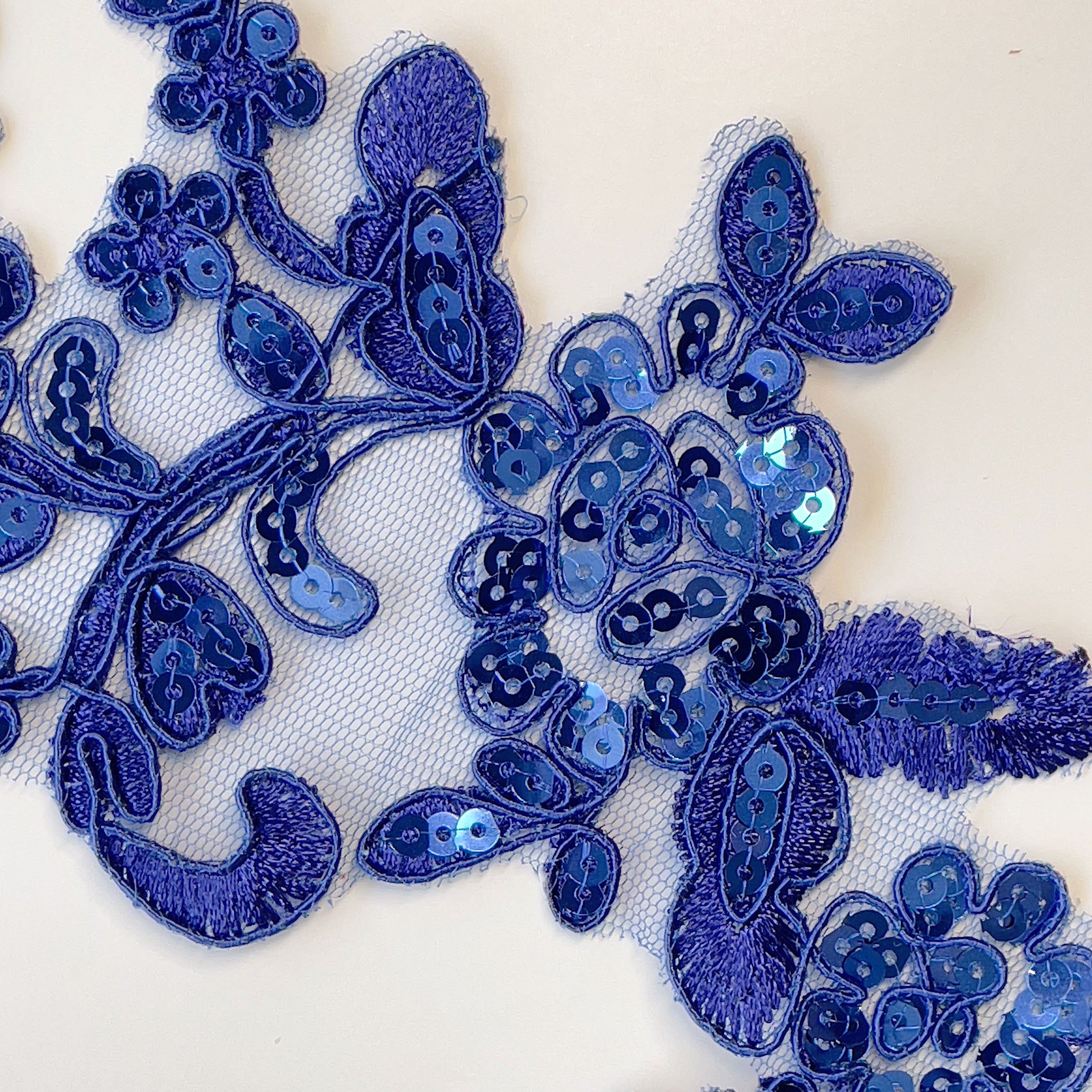 Heavily sequinned royal blue embroidered and corded floral lace applique pair.