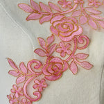 Pink embroidered floral applique with a rose pattern.  Gold cord outlines all the flower, leaf and stem shapes and the rose petals.  A bold applique which will stand out against the costume fabric. 