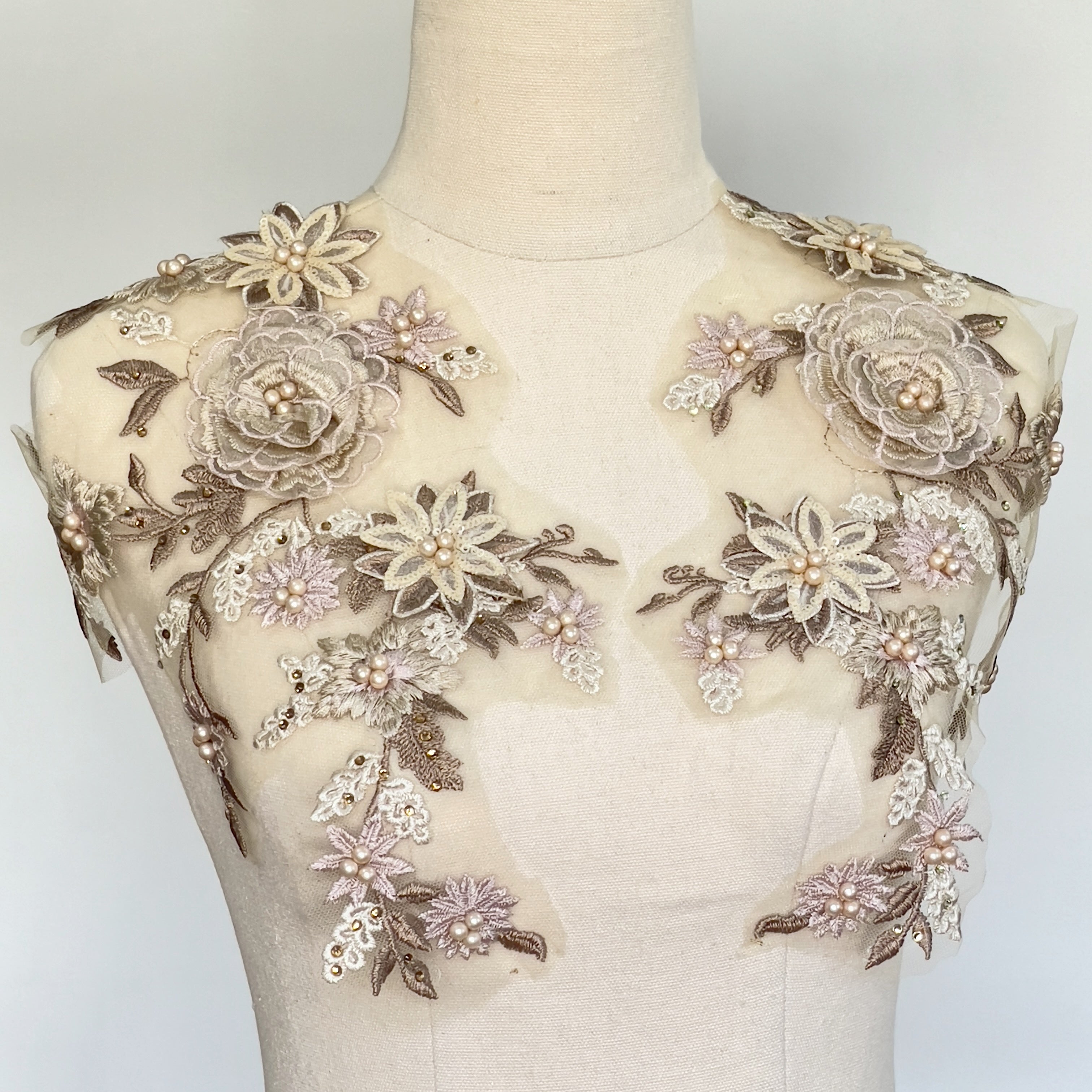Champagne , blush pink and chocolate brown applique with 3d flowers and studded  faux pearls. displayed on a mannequin .