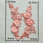 Pink lace applique pair embellished with 3D fabric flowers laying a white background which shows the measurements  of the appliques.